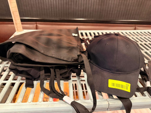 (1) LOT OD ASSORTED ALL BLACK APRONS, HATS, AND VISORS.