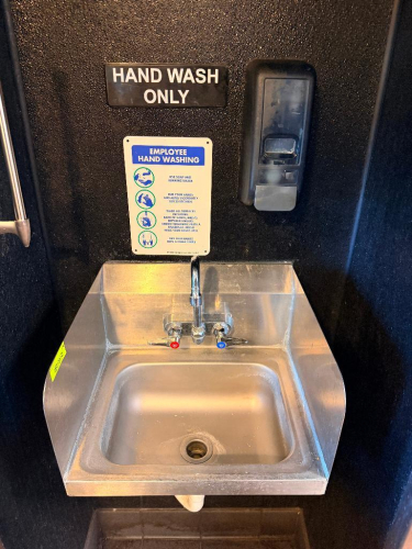 WALL MOUNTED STAINLESS HAND SINK.