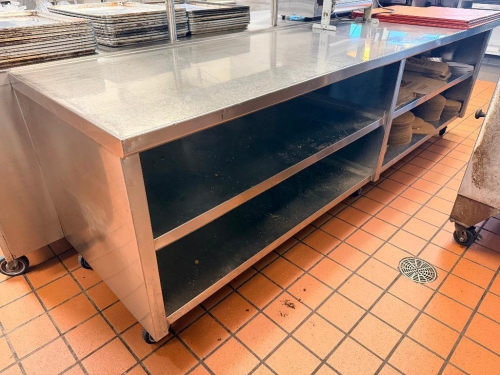 120"W X 32"D STAINLESS STEEL WORK / PREP TABLE WITH UNDERSHELF STORAGE AND FILM / WRAP DISPENSER. UNIT FEATURES HEAVY-DUTY CONSTRUCTION, OPEN BASE SHELVING FOR STORAGE, AND CASTERS