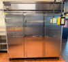 CONTINENTAL THREE DOOR REACH-IN REFRIGERATOR WITH TOP-MOUNT COMPRESSOR HOUSING. UNIT FEATURES THREE SOLID SWING DOORS, MULTIPLE INTERIOR WIRE SHELVES, AND CASTERS - 2