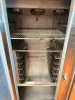 CONTINENTAL THREE DOOR REACH-IN REFRIGERATOR WITH TOP-MOUNT COMPRESSOR HOUSING. UNIT FEATURES THREE SOLID SWING DOORS, MULTIPLE INTERIOR WIRE SHELVES, AND CASTERS - 4