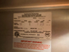 CONTINENTAL THREE DOOR REACH-IN REFRIGERATOR WITH TOP-MOUNT COMPRESSOR HOUSING. UNIT FEATURES THREE SOLID SWING DOORS, MULTIPLE INTERIOR WIRE SHELVES, AND CASTERS - 5