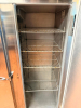CONTINENTAL THREE DOOR REACH-IN REFRIGERATOR WITH TOP-MOUNT COMPRESSOR HOUSING. UNIT FEATURES THREE SOLID SWING DOORS, MULTIPLE INTERIOR WIRE SHELVES, AND CASTERS - 6