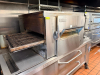 LINCOLN CONVEYOR OVEN WITH FRONT-LOAD DOOR AND EXTENDED CONVEYOR BELT SYSTEM. UNIT FEATURES DIGITAL CONTROL PANEL, VIEWING WINDOW