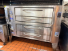 BAKERS PRIDE Y-800 DOUBLE STACK GAS DECK OVENS. UNIT FEATURES MANUAL CONTROLS, STONE DECK INTERIORS, AND HEAVY-DUTY DOOR HANDLES.