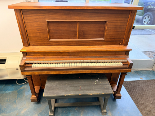 UPRIGHT ACOUSTIC PIANO WITH BENCH &ndash; WALNUT FINISH, TRADITIONAL STYLE. FEATURES FULL KEYBOARD AND INTERNAL ACTION LABELED &ldquo;VERTICAL GRAND &ndash; FRENCH REPEATING ACTION.