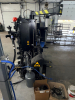 HEAVY DUTY TIRE CHANGER MACHINE WITH INTEGRATED BEAD BREAKER, SWING ARM ASSEMBLY, AND CONTROL PANEL WITH PRESSURE GAUGE. WITH ATTACHED ACCESSORIES AND AIR LINES PRESENT. INDUSTRIAL GRADE CONSTRUCTION WITH ELECTRO-PNEUMATIC OPERATION. - 6