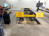 12,000 LB. CAPACITY HEAVY DUTY IN-GROUND SCISSOR VEHICLE LIFT WITH DUAL RUNWAYS AND INTEGRATED CENTER JACK, HYDRAULIC SYSTEM WITH STANDALONE CONTROL COLUMN. WITH DATA PLATES AND SAFETY LABELS PRESENT. SOLID INDUSTRIAL CONSTRUCTION WITH 12,000 LB. MAIN LI - 2