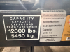 12,000 LB. CAPACITY HEAVY DUTY IN-GROUND SCISSOR VEHICLE LIFT WITH DUAL RUNWAYS AND INTEGRATED CENTER JACK, HYDRAULIC SYSTEM WITH STANDALONE CONTROL COLUMN. WITH DATA PLATES AND SAFETY LABELS PRESENT. SOLID INDUSTRIAL CONSTRUCTION WITH 12,000 LB. MAIN LI - 12