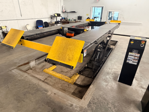 12,000 LB. CAPACITY HEAVY DUTY IN-GROUND SCISSOR VEHICLE LIFT WITH INTEGRATED CENTER JACK, HYDRAULIC OPERATION, AND FULL LENGTH RUNWAYS. UNIT FEATURES DUAL PLATFORM DESIGN WITH YELLOW APPROACH RAMPS AND CONTROL STATION, IDENTIFICATION PLATES AND SAFETY CE