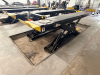 12,000 LB. CAPACITY HEAVY DUTY IN-GROUND SCISSOR VEHICLE LIFT WITH INTEGRATED CENTER JACK, HYDRAULIC OPERATION, AND FULL LENGTH RUNWAYS. UNIT FEATURES DUAL PLATFORM DESIGN WITH YELLOW APPROACH RAMPS AND CONTROL STATION, IDENTIFICATION PLATES AND SAFETY CE - 14