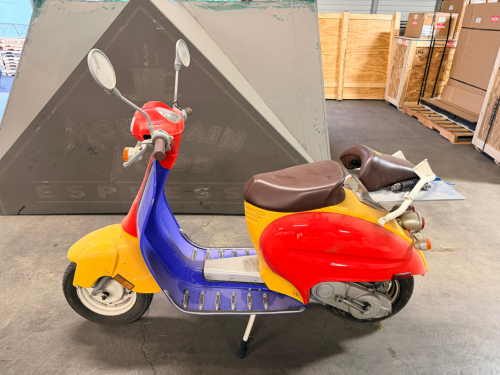ITALJET SCOOTER WITH DUAL SEAT CONFIGURATION AND MULTICOLOR BODY PANELS. UNIT SHOWS NORMAL WEAR WITH SCUFFING AND COSMETIC IMPERFECTIONS THROUGHOUT. ODOMETER READS APPROXIMATELY 2,136 MILES; FUNCTIONAL CONDITION UNKNOWN.