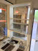 OUTDOOR KIOSK UNIT WITH GLASS SERVICE WINDOWS, INTERIOR CABINETRY, MULTIPLE SINK BASINS, UNDERCOUNTER REFRIGERATION, AND ROOF MOUNTED HVAC UNIT. UNIT FEATURES PAINTED METAL EXTERIOR, ACCESS DOOR, INTERIOR LIGHTING, ELECTRICAL PANEL, AND PLUMBING CONNECTIO - 23