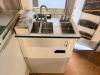 OUTDOOR KIOSK UNIT WITH GLASS SERVICE WINDOWS, INTERIOR CABINETRY, MULTIPLE SINK BASINS, UNDERCOUNTER REFRIGERATION, AND ROOF MOUNTED HVAC UNIT. UNIT FEATURES PAINTED METAL EXTERIOR, ACCESS DOOR, INTERIOR LIGHTING, ELECTRICAL PANEL, AND PLUMBING CONNECTIO - 27