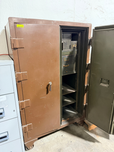 LARGE HEAVY-DUTY DOUBLE DOOR SAFE WITH MULTIPLE INTERIOR COMPARTMENTS AND SHELVING. FEATURES INNER LOCKING COMPARTMENTS AND STEEL CONSTRUCTION FOR SECURE STORAGE