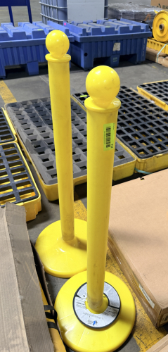 (2) YELLOW PLASTIC STANCHION POSTS.