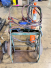 OXY-ACETYLENE WELDING CART WITH HOSES, TORCH HANDLE, AND REGULATORS. INCLUDES DUAL GAUGES AND EXTENDED HOSE LENGTH.