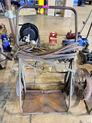OXY-ACETYLENE WELDING CART WITH HOSES, TORCH HANDLE, AND REGULATORS. INCLUDES DUAL GAUGES AND EXTENDED HOSE LENGTH.