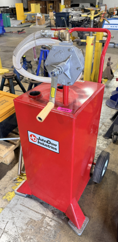 PORTABLE FUEL TRANSFER CADDY WITH HAND OPERATED PUMP AND HOSE ASSEMBLY. INCLUDES WHEELS, HANDLE, AND DISPENSING HOSE WITH NOZZLE AS SHOWN