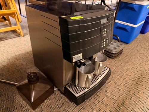 VERISMO 701 COMMERCIAL ESPRESSO / COFFEE MACHINE WITH DUAL DISPENSERS, INTEGRATED STEAM WAND, CONTROL PANEL WITH MULTIPLE BREW SETTINGS, AND REMOVABLE DRIP TRAY, ACCOMPANIED BY WATER RESERVOIR AND METAL PITCHERS.