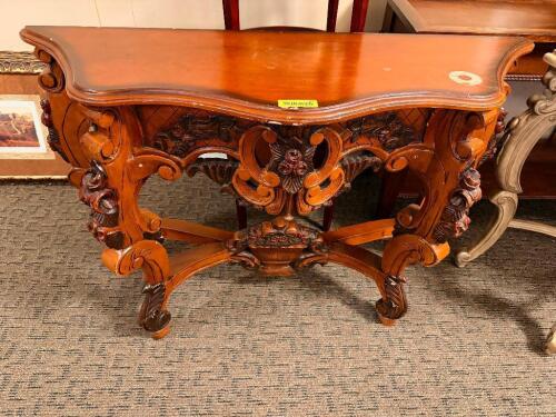 32 IN W X 17 WOOD CONSOLE TABLE WITH SHAPED TOP, PIERCED APRON, AND HEAVY FLORAL AND SCROLL MOTIF DECORATION