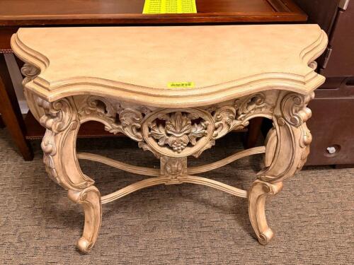 32 IN W X 17 WOOD CONSOLE TABLE WITH SCROLLED LEGS, PIERCED APRON, AND CENTRAL FLORAL MEDALLION, FEATURING A SHAPED TOP WITH DECORATIVE EDGE DETAIL AND DISTRESSED FINISH