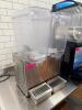 CRATHCO DOUBLE TANK COLD BEVERAGE DISPENSER WITH CLEAR POLYCARBONATE HOPPERS, STAINLESS STEEL BASE, AND DUAL DRIP TRAYS. - 2