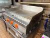 THERMOSTATIC FLAT TOP GRIDDLE WITH THREE BURNER CONTROLS, HEAVY GAUGE STEEL COOKING SURFACE, AND FRONT GREASE TROUGH. UNIT FEATURES MANUAL IGNITION SWITCH WITH INDICATOR LIGHTS AND STAINLESS STEEL BODY. - 2