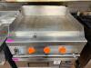 THERMOSTATIC FLAT TOP GRIDDLE WITH THREE BURNER CONTROLS, HEAVY GAUGE STEEL COOKING SURFACE, AND FRONT GREASE TROUGH. UNIT FEATURES MANUAL IGNITION SWITCH WITH INDICATOR LIGHTS AND STAINLESS STEEL BODY. - 3
