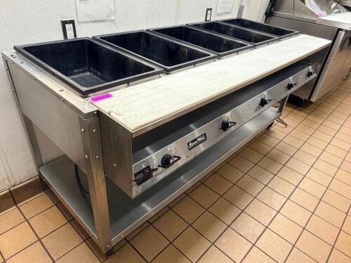 VOLLRATH SERVEWELL ELECTRIC STEAM TABLE WITH FIVE WELL PAN CONFIGURATION AND STAINLESS STEEL CONSTRUCTION. UNIT FEATURES INDIVIDUAL HEAT CONTROLS FOR EACH WELL AND OPEN BASE STORAGE SHELF.
