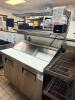 TRUE STAINLESS STEEL SANDWICH PREP TABLE WITH RAISED INGREDIENT RAIL AND DOUBLE DOOR REFRIGERATED BASE. UNIT INCLUDES OVERHEAD SHELF ASSEMBLY AND CUTTING SURFACE WITH LIFT-UP LID. - 3