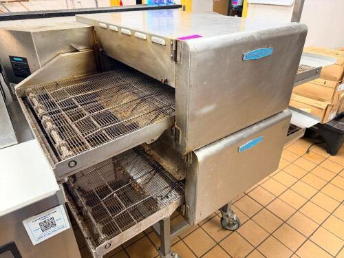 TURBOCHEF DOUBLE STACK COMMERCIAL ELECTRIC CONVEYOR OVENS WITH STAINLESS STEEL CONSTRUCTION AND DIGITAL CONTROL INTERFACE. INCLUDES DUAL CONVEYOR CHAMBERS MOUNTED ON MOBILE STAND WITH CASTERS.