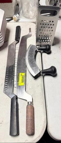 (2) CHEESE WIRES, (1) ROCKER KNIFE, AND (1) CHEESE SHREDDER.