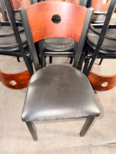(12) METAL CHAIRS W/ WOODEN BACKS AND BLACK VINYL SEATS.