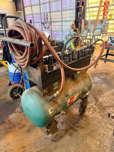 AIR COMPRESSOR TANK WITH MOUNTED TOOL RACK, ASSORTED IMPACT SOCKETS, PNEUMATIC IMPACT WRENCH, AND AIR HOSE.