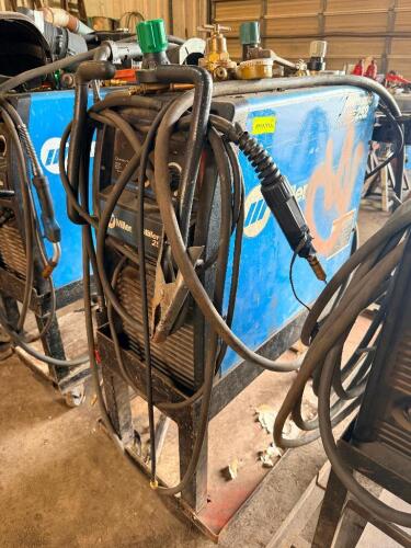 MILLER MILLER MATIC 252 MIG WELDER WITH CART, LEADS, GUN, GROUND CLAMP, MULTIPLE REGULATORS AND TORCHES. INCLUDES ADDITIONAL GAS REGULATORS AND ACCESSORIES.