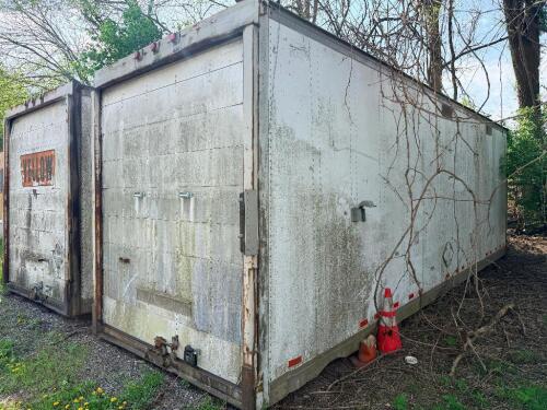 24' DRY VAN STORAGE TRAILER / VAN BODY (NO RUNNING GEAR), STEEL FRAME WITH ALUMINUM/COMPOSITE PANELS, REAR SWING DOORS, USED FOR GROUND STORAGE. UNIT SHOWS HEAVY WEATHERING, SURFACE RUST ON FRAME AND DOOR HARDWARE, AND GENERAL AGE-RELATED WEAR.