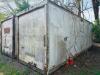 24' DRY VAN STORAGE TRAILER / VAN BODY (NO RUNNING GEAR), STEEL FRAME WITH ALUMINUM/COMPOSITE PANELS, REAR SWING DOORS, USED FOR GROUND STORAGE. UNIT SHOWS HEAVY WEATHERING, SURFACE RUST ON FRAME AND DOOR HARDWARE, AND GENERAL AGE-RELATED WEAR.