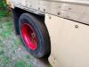 24' DRY VAN TRAILER BODY WITH ROLL-UP REAR DOOR, WOOD INTERIOR WALLS, WOOD FLOORING, AND STEEL FRAME CONSTRUCTION. UNIT SHOWS HEAVY WEAR INCLUDING RUST, CORROSION, SIDE PANEL DAMAGE, AND WEATHERING. REAR LIGHTING PRESENT, SINGLE AXLE CONFIGURATION, AND EX - 6