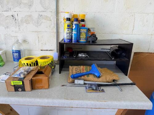 (1) LOT OF MISC SPRAYS, CAUTION TAPE, AND SMALL ORGANIZER SHELF.