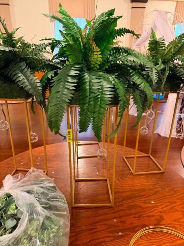 (4) METAL FRAMED PLANT STANDS W/ FAUX FERN PLANTS.
