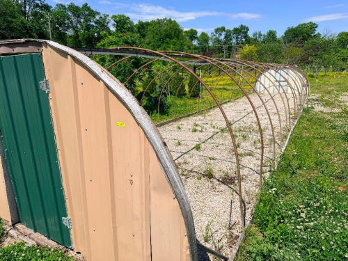 HOOP STYLE METAL GREEN HOUSES WITH PARTIAL PANEL ENCLOSURE AND DOUBLE DOOR END, ARCHED STEEL RIB CONSTRUCTION
