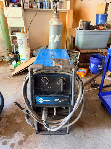 MILLER MIG WELDER UNIT WITH ATTACHED CABLES AND HOSE, MOUNTED ON WHEELED BASE