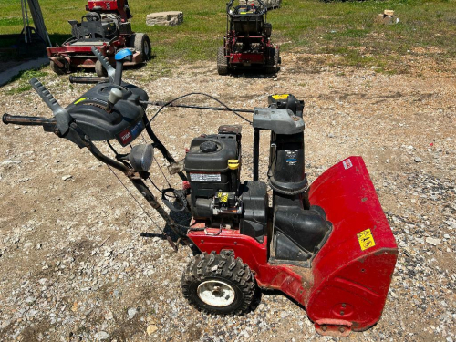 TORO POWER MAX TWO-STAGE SNOW BLOWER WITH GAS ENGINE, SELF-PROPELLED DRIVE, CHUTE ROTATION CONTROL, AND AUGER SYSTEM.