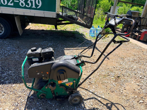 RYAN WALK-BEHIND POWER AERATOR WITH DRUM-MOUNTED CORING TINES, STEEL FRAME, AND MANUAL CONTROL HANDLE SYSTEM