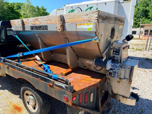 FISHER STAINLESS STEEL V-BOX TRUCK MOUNT SALT SPREADER WITH ELECTRIC AUGER/CHAIN DRIVE, REAR SPINNER ASSEMBLY, IN-CAB CONTROLS, AND WOOD SIDE EXTENSIONS.