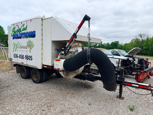 ODDB LEAF COLLECTION TRAILER WITH ENCLOSED DEBRIS BOX, VACUUM INTAKE HOSE, HYDRAULIC LIFT ARM, CONTROL PANEL, TANDEM AXLE, AND DIESEL POWER UNIT.