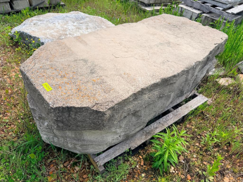 STONE SLAB WITH IRREGULAR CUT EDGES AND WEATHERED SURFACE.