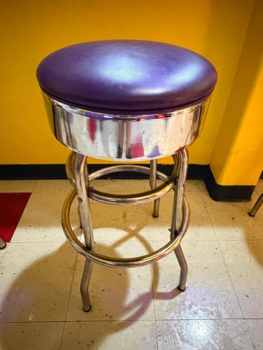 (2) RETRO-STYLE COMMERCIAL BAR STOOL WITH PADDED PURPLE VINYL SEAT.
