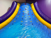 COMMERCIAL INFLATABLE SLIPPERY SLOPE SLIDE WITH PADDED ENTRY, HIGH SIDEWALLS, AND ENCLOSED LANDING AREA. UNIT FEATURES MULTI-COLOR VINYL CONSTRUCTION WITH TOP SAFETY NETTING. - 8